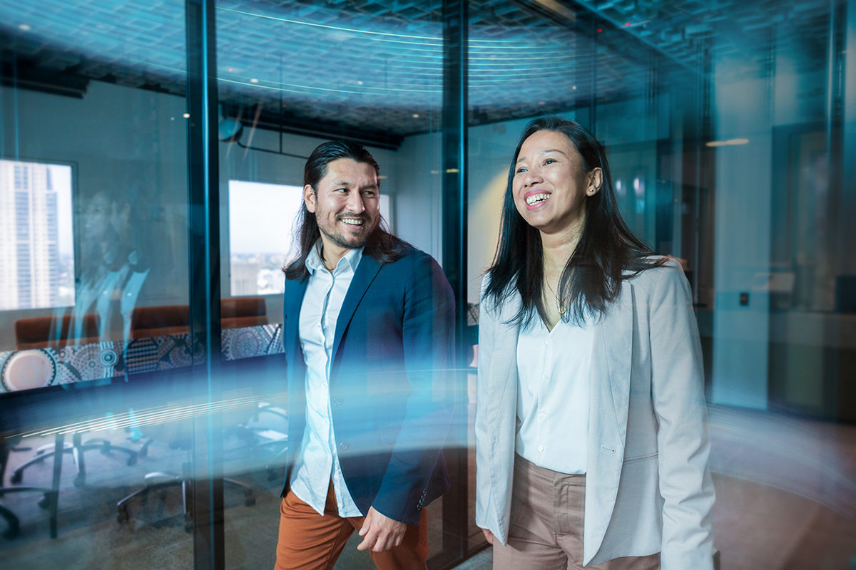 Image of two people walking and laughing